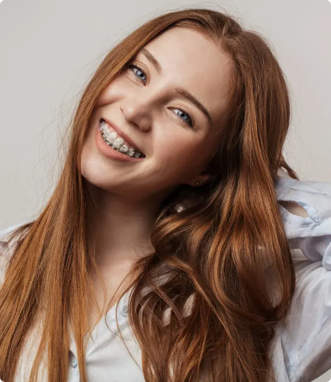 Smiling patient wearing clear ceramic braces at Moroco Orthodontics